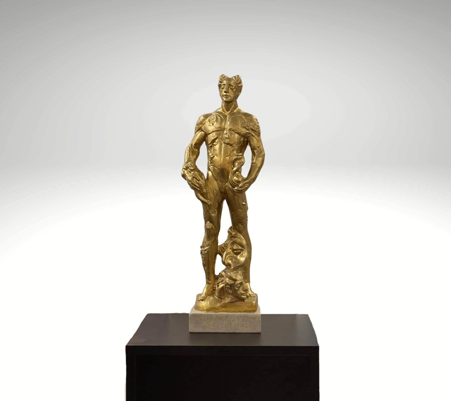 Portrait of Sculpture by Valeri Sokolovski gold hydrostone figurative sculpture with surreal faces and symbolic human form